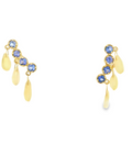 Gold earrings with blue/purple tanzanites with dangling opals on a white background