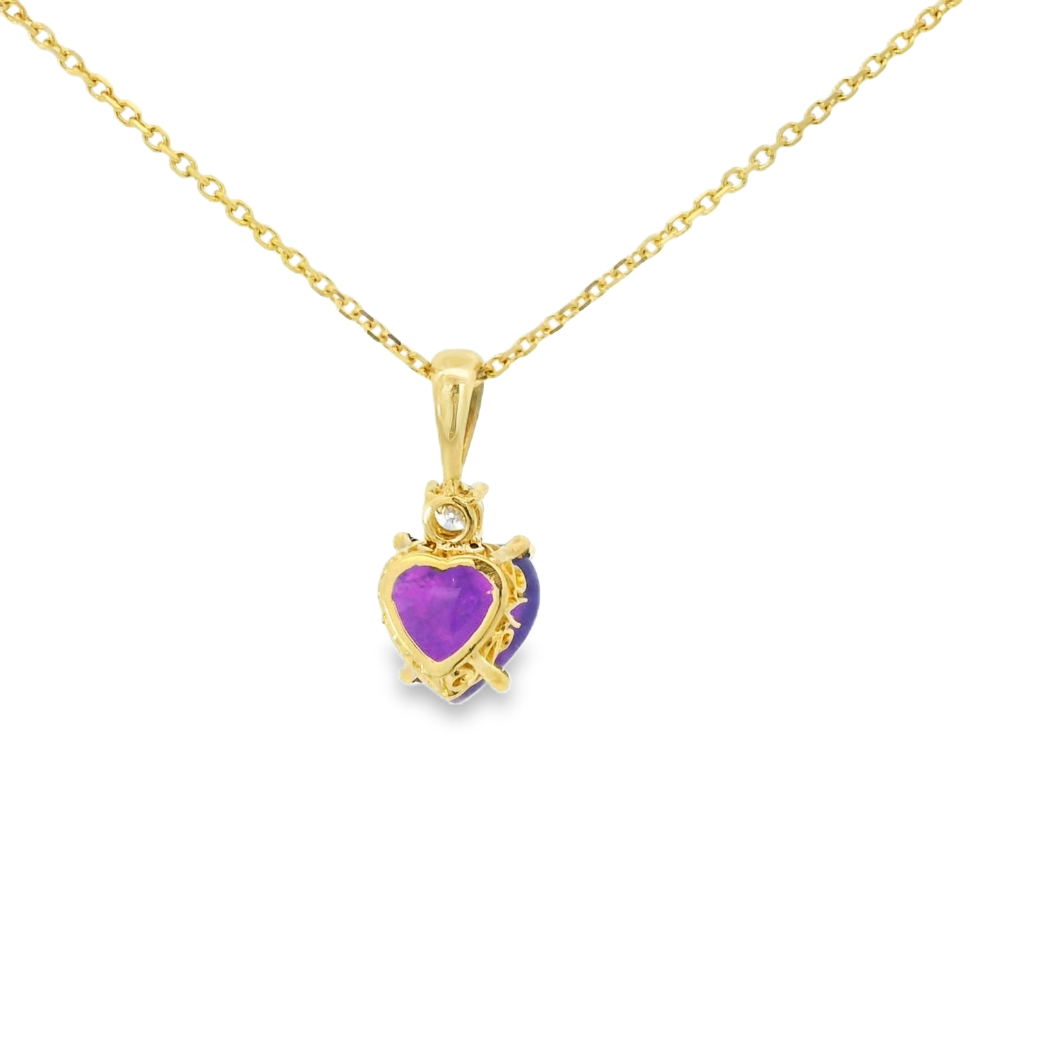 Gold necklace with a heart-shaped purple gemstone pendant on a white background