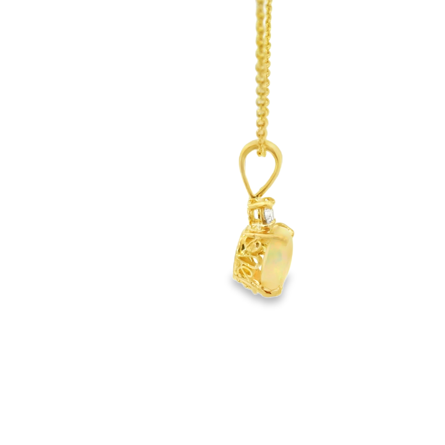 Gold necklace with a heart-shaped pendant on a white background