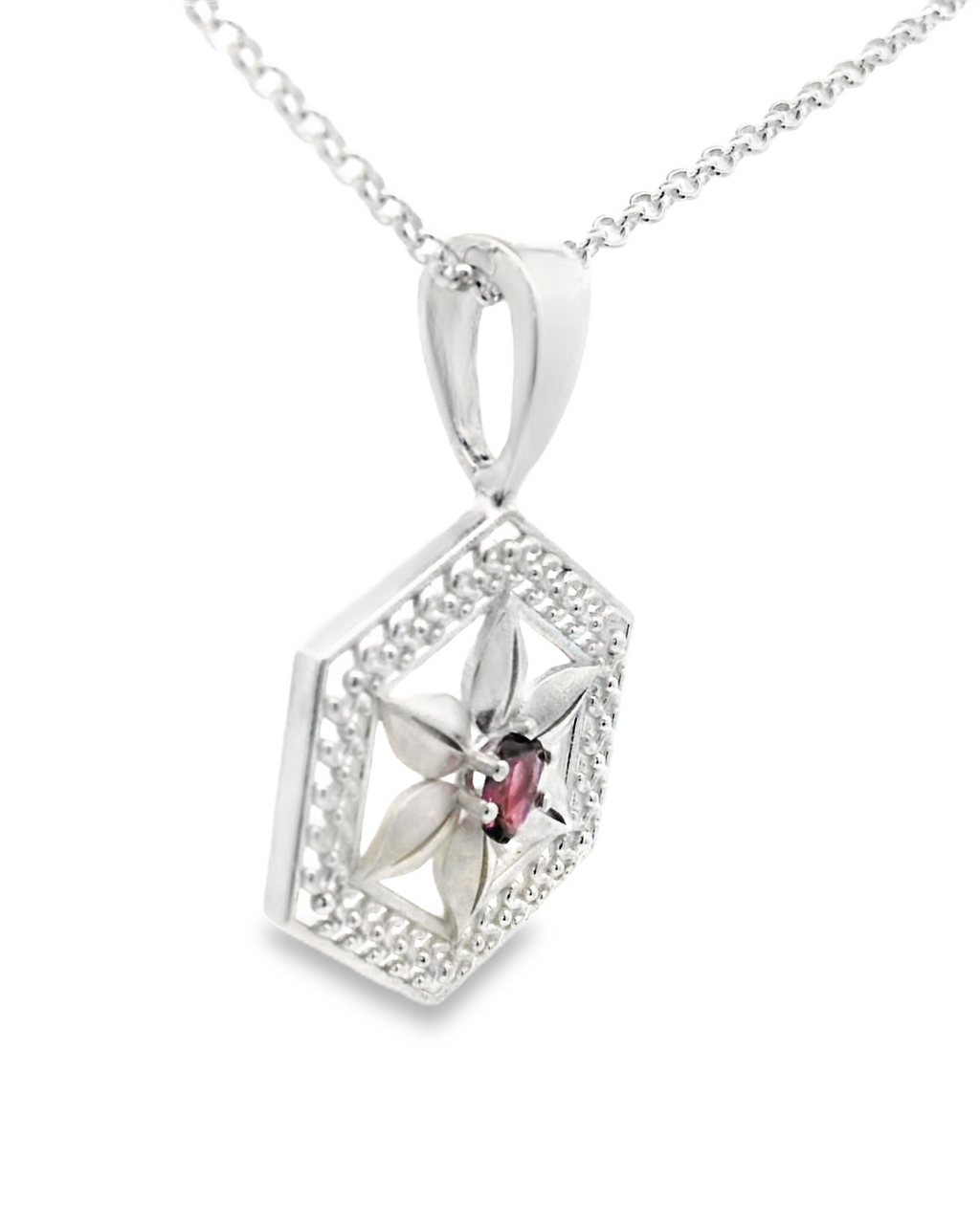 Silver hexagonal pendant with a spinel gemstone on a white background