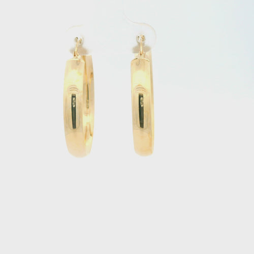 Video of Pair of gold hoop earrings on a white background